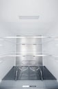 Wine bottle holders in the cold storage compartment. An empty refrigerator. Inside an empty, clean refrigerator, a Royalty Free Stock Photo