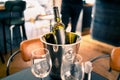 Wine bottle in ice bucket on restaurant or bar table. Drink cooler in pub. White sauvignon blanc, chardonnay or riesling.