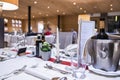 Wine bottle in ice bucket on table with elegant place setting in luxury hotel Royalty Free Stock Photo