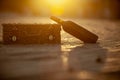 Wine bottle laying near straw chest on sand beach Royalty Free Stock Photo