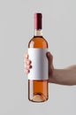 Wine Bottle Mock-Up. Blank Label - Male hands holding a wine bottle on a gray background Royalty Free Stock Photo