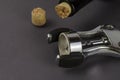 Wine bottle, old corkscrew and broken cork on a gray background Royalty Free Stock Photo