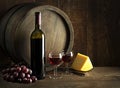 Wine bootle and glasses with cheese on wooden table Royalty Free Stock Photo