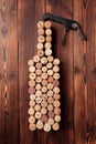 Wine bottle shaped corks and corkscrew over rustic wooden table background and burlap. Top view with copy space - image Royalty Free Stock Photo