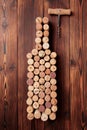 Wine bottle shaped corks and corkscrew over rustic wooden table background and burlap. Top view with copy space - image Royalty Free Stock Photo