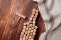 Wine bottle shaped corks and corkscrew over rustic wooden table background and burlap. Top view with copy space - image Royalty Free Stock Photo