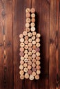 Wine bottle shaped corks and corkscrew over rustic wooden table background and burlap. Top view with copy space - image Royalty Free Stock Photo