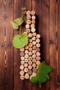 Wine bottle shaped corks and corkscrew over rustic wooden table background and burlap. Top view with copy space - image Royalty Free Stock Photo