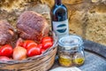 Wine bottle, tomatoes and bread, food concept