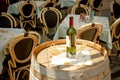 Wine bottle and wineglasses on barrel in street ca Royalty Free Stock Photo