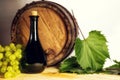 Wine bottle, wooden barrel and white grapes. Royalty Free Stock Photo