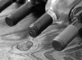 Wine bottle on wooden desk black and white. Unusual perspective view from above horizontal, selective focus Royalty Free Stock Photo