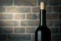 Wine bottle on a wooden table with bricks wall background close Royalty Free Stock Photo