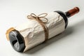 A wine bottle wrapped in white paper, mockup isolated on white background Royalty Free Stock Photo