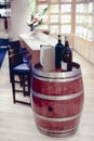 Wine bottles and barrel in winery cellar shop