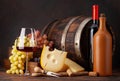 Wine bottles, grapes, cheese and glass of red wine Royalty Free Stock Photo