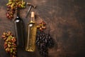 Wine bottles with grapes and wineglasses on old dark wooden table background with copy space. Red wine with a vine branch. Wine Royalty Free Stock Photo