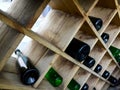 Wine bottles lie on the shelves in the form of a rhombus