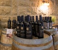 Wine bottles of Psagot winery stand on wine barrels in the visitor center in Samaria region in Benjamin district, Israel