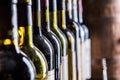 Wine bottles in row and oak wine keg Royalty Free Stock Photo