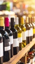 Wine Bottles on Shelf with Variety of Red and White Wines in a Row Royalty Free Stock Photo