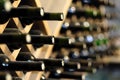 Wine bottles stacked on wooden racks