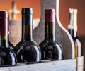 Wine bottles in wooden crate and oak wine keg.