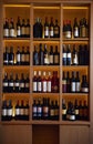 Wine bottles on a wooden shelf. Royalty Free Stock Photo