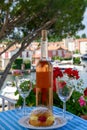 Wine and cake of French Riviera, glasses of cold rose Cote de Provence wine and Tarte Tropezienne cake in yacht harbour of Port