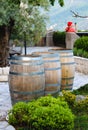Wine casks at the winery. Wine barrels outside of wine cellar in the garden of a picturesque vineyard. Winery garden in details Royalty Free Stock Photo