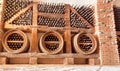 Wine cellar in bar, winery or hotel, with glass bottles stuck in rustic wooden shelves of rural storage. Royalty Free Stock Photo