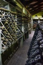 Wine cellar. The bottles on wooden shelves. Vintage storage of wine collection Royalty Free Stock Photo