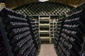 Wine cellar. The bottles on wooden shelves. Vintage storage of wine collection Royalty Free Stock Photo