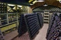Wine cellar. The bottles on wooden shelves. Vintage storage of wine collection Royalty Free Stock Photo