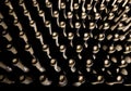 Wine cellar low light interior shot. Wine glass bottle necks with corks backgrounds with a collection of wine bottles. Money Royalty Free Stock Photo