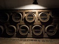 Wine cellar low light interior shot. Old wooden shelves with a collection of wine bottles. Money investing and winemaking or