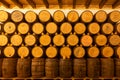 A wine cellar with many wine barrels stacked along the wall Royalty Free Stock Photo