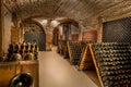 Wine cellar, a row of champagne bottles Royalty Free Stock Photo