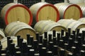 Wine cellar with wooden barrels and filled glass bottles 3 Royalty Free Stock Photo