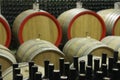 Wine cellar with wooden barrels and filled glass bottles 7 Royalty Free Stock Photo