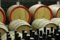 Wine cellar with wooden barrels and filled glass bottles 3 Royalty Free Stock Photo