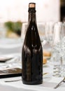 Wine champagne cider dark glass bottle blanck space in fancy table set in restaurant event celebration Royalty Free Stock Photo