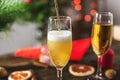 Wine champagne pours into a glass on the background of bokeh garlands. Festive Christmas table on new year`s eve Royalty Free Stock Photo