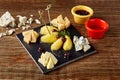 Wine and cheese plate - four kinds of cheese, pear, honey. Excellent appetizer wine. Royalty Free Stock Photo