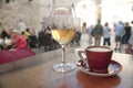 Wine and coffee at a cafe, crowded street background Royalty Free Stock Photo