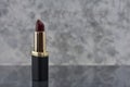 Wine colored lipstick with black seen up close