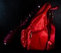 A wine colored umbrella with a red school bag shot against black board haing stains of white chalk -monsoon and schools concept Royalty Free Stock Photo