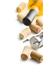 Wine cork, corkscrew and bottle of white wine