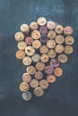 Wine corks grape shape and vine on stone table. Top view with copy space for your text. Royalty Free Stock Photo