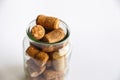 Wine corks lie in a glass jar on a white background Royalty Free Stock Photo